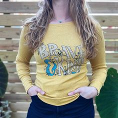 Brave & Kind | Mustard Long Sleeve | Medium. Spring Long Sleeve Tops With Lettering, Long Sleeve Slogan T-shirt, Relaxed Fit Long Sleeve Tops With Lettering, Yellow Relaxed Fit Long Sleeve T-shirt, Trendy Long Sleeve Tops With Lettering, Long Sleeve T-shirt With Lettering, Trendy Long Sleeve T-shirt With Lettering, Inspirational Long Sleeve Cotton T-shirt, Inspirational Long Sleeve T-shirt With Graphic Print