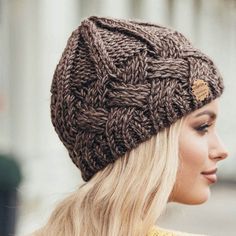 a woman with blonde hair wearing a brown knitted hat