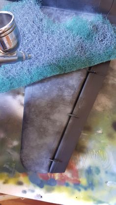 a close up of a metal sink with blue rugs on the top and bottom