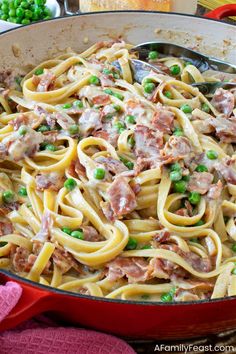 pasta with meat and peas in a red skillet