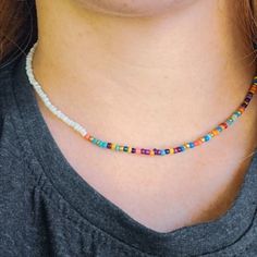 Handmade seed bead choker, boho beaded necklace. Elastic multi color tiny beaded necklace. White Bohemian Choker With Colorful Beads, Colorful Beaded White Jewelry For Festivals, Trendy White Beads For Festival, White Jewelry With Colorful Beads For Festival, White Beaded Bohemian Choker, Festival White Jewelry With Colorful Beads, Trendy White Festival Beads, White Bohemian Beaded Choker, White Tiny Beads Choker