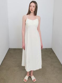 Soft and drapery, this sleeveless dress has minimalistic silhouette in long length. It is accentuated with voluminous tucked detail at chest, and has adjustable halterneck strap.  - Airy and crisp nylon fabric- Flare hem in maxi length- Fitted waist for feminine mood- Back zip fastenings- Logo embroidery detail at side Spring Midi-length Slip Dress With Lined Bodice, Sleeveless Halter Dress With Ruched Fitted Bodice, Ruched Sleeveless Halter Dress With Fitted Bodice, Ruched Halter Dress With Fitted Bodice, Chic Midi Dress With Lined Bodice For Daywear, Daywear Dress With Ruched Bodice And Straight Neckline, Summer Midi-length Slip Dress With Lined Bodice, Summer Midi Slip Dress With Lined Bodice, Fitted Bodice Slip Dress With Spaghetti Straps For Daywear