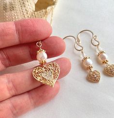 "Elevate your elegance with this beautiful minimalist gold heart necklace and earrings set with white pearls. The dainty 18K gold-plated brass cubic zirconia heart pendant adds a touch of sophistication, complemented by a 16\" gold-plated chain with a secure lobster clasp. The handmade earring hooks feature 10K gold-filled wire, adorned with fresh water pearls, aura Quartz, and gold-plated beads for a delicate and timeless design. This listing offers a gold heart jewelry set, providing the perfe 14k Gold Filled Heart Charm Jewelry For Wedding, Elegant Gold Plated Heart Earrings As Gift, Wedding Jewelry With 14k Gold-filled Heart Charm, Wedding Jewelry With 14k Gold Filled Heart Charm, Gold Plated Heart Pendant Earrings For Wedding, Elegant Heart Pendant Earrings For Weddings, Elegant Heart Shaped Earrings For Gift, Elegant Gold Plated Heart Earrings For Wedding, Elegant Heart Charm Earrings As Gift For Her