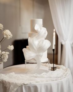 a white wedding cake sitting on top of a table