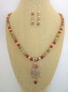 "3 Piece Jewelry Set. Pendant-Rare Fossil Coral and .925 Silver Pendant,2.25 drop including heart motif w/carnelian bead Necklace - 6 mm Rainbow Jasper beads,Carnelian, Silver beads.21 inches w/3 inch extender .925 chain and hook Earrings - 6 mm Rainbow Jasper Agate beads, 2\" drop  Earrings on Sterling Ear wires. The inch diameter Fossil Coral, is made from the preserved skeletons of marine coral  (which is not to be confused with endangered coral).  Flower-like patterns are left in the fossili Multicolor Carnelian Round Bead Jewelry, Multicolor Carnelian Bead Jewelry, Multicolor Round Carnelian Bead Jewelry, Carnelian 8mm Beads Jewelry, Ocean Jasper Round Beads Jewelry As Gift, Ocean Jasper Round Beads Jewelry Gift, Ocean Jasper Round Beads As A Gift, Round Jasper Healing Jewelry, Round Jasper Jewelry For Healing