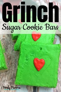 green sugar cookie bars with red hearts on them and text overlay that reads, grin