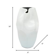 a white vase sitting on top of a table next to a black and white line