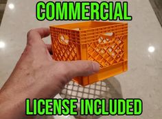 a hand holding an orange plastic crate with the words commercial license included