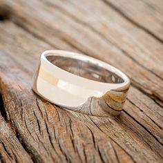 a silver ring sitting on top of a wooden table