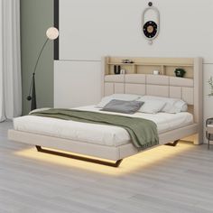 a white bed sitting in a bedroom on top of a hard wood floor