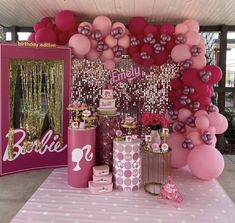 a pink and gold birthday party with balloons