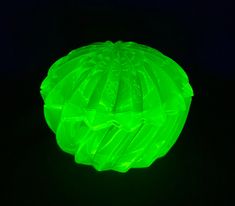 a green plastic object is glowing in the dark