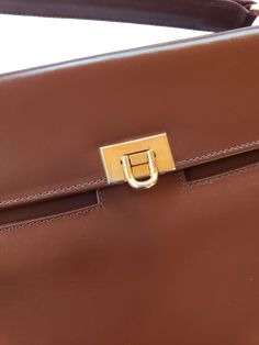 Details: Brand: I.Magnin (Made in Italy) Cocoa Brown Leather Length: 11.25" Height: 8" Width: 1.5 - 3.5" Accordian style interior Metal clasp Cross-body Strap included Interior center zip pocket Small zip interior pocket Small Patch interior pocket Designer Formal Tote Flap Bag, Formal Handheld Bag With Palladium Hardware, Designer Rectangular Briefcase With Gold-tone Hardware, Designer Handheld Flap Bag For Formal Events, Designer Handheld Flap Bag For Formal Occasions, Designer Handheld Business Shoulder Bag, Classic Handheld Flap Bag, Tan Top Handle Satchel For Formal Events, Formal Tan Top Handle Satchel