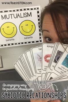 a woman holding up some cards with smiley faces on them and the caption says, symbolic relationss