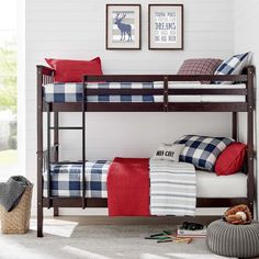 a bunk bed with plaid sheets and pillows in a child's playroom or bedroom