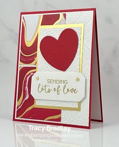 a close up of a greeting card with a heart on the front, and a tag that says sending love to all of us