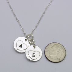 Keep your loved ones with you always, with this classic circle fingerprint with birthstone charm necklace. Handcrafted in solid sterling silver, this necklace features a beautiful circle fingerprint pendants hanging at different levels from your choice of chain. This trendy charm necklace design is both simple and elegant. The necklace is available with different charm sizes, different chains and different necklace lengths. With its durable construction and timeless design, this necklace is sure Minimalist Hand Stamped Sterling Silver Necklaces, Minimalist Hand Stamped Heart Pendant Jewelry, Everyday Hand Stamped Sterling Silver Necklaces, Everyday Hand Stamped Heart Pendant Jewelry, Sterling Silver Initial Pendant Charm Necklace For Anniversary, Mother's Day Sterling Silver Round Disc Charm Necklace, Sterling Silver Hand Stamped Initial Pendant Necklace, Hand Stamped Heart Sterling Silver Charm Necklace, Sterling Silver Hand Stamped Heart Charm Necklace