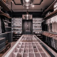 a walk - in closet with lots of clothes and other items on the shelves,