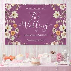 the wedding sign is hanging above a table with cakes and desserts on it's side