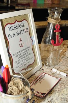 a message in a bottle on a table next to a vase with writing and markers