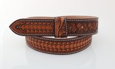 --- Leather Belt Width: 1.5" --- Premium Full-Grain Leather. --- Belt thickness 3.2 mm --- Easy Snap System for Interchanging Buckles --- Each product is one-of-a-kind and made from part of a whole hide of leather. The frontside is smooth and finished while the backside contains the grain fibers that indicate a true leather product. There will be unique variation from item to item that truly makes it your own.  The Perfect Fit: ---  Take an old belt (that still fits) and measure from the base of Traditional Brown Leather Belt Buckles, Traditional Hand Tooled Leather Belt Buckles, Classic Brown Hand Tooled Belt Buckles, Classic Hand Tooled Brown Belt Buckles, Western Leather Embossed Belt Buckles, Classic Brown Embossed Belt Buckles, Adjustable Engraved Brown Belt, Belt With Buckle, Leather Product