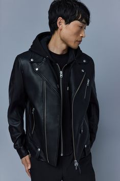 MAGNUS is a classic biker for men crafted from supple lamb leather. Expertly tailored for a slim fit, it features a removable contrast hooded bib made from plush double face jersey. The asymmetrical closure, notch collar, and studded tabs bring signature detailing. Action back paneling adds to the comfortable feel. A modern and modular statement layer. Leather biker jacket Lamb leather Light: Up to 5°C Removable double face jersey bib with adjustable drawcord hood and centre front zip closure As Biker Jacket Men, Man Crafts, Black Leather Biker Jacket, Black Down, Mens Black Leather, Leather Shirt, Notch Collar, Leather Motorcycle Jacket, Leather Biker Jacket