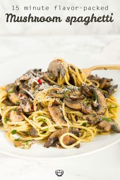 pasta with mushrooms and parmesan cheese on a white plate