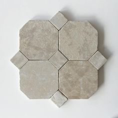 several white hexagonal tiles on a white surface, arranged in the shape of an octagon