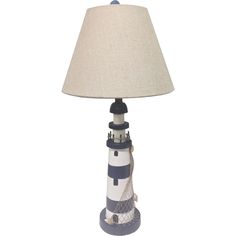 a lamp with a lighthouse on it and a light shade in front of the lamp