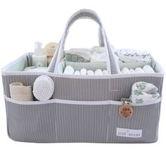 a large gray and white striped bag filled with baby items