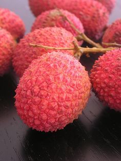 small red fruit sitting on top of a wooden table