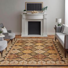 a living room with two couches and a rug in front of a fire place