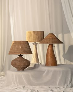 three lamps sitting on top of a white table