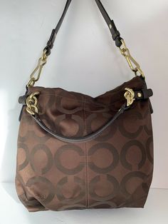 Coach Madison Brook brown canvas Op Art 14147 Satchel purse EUC. Condition is "Pre-owned". Shipped with USPS Priority Mail. Preowned like new condition smoke-free Color Brow gold hardware genuine leather handles Size medium Double handle Shoulder strap Removable Formal Brown Canvas Shoulder Bag, Formal Brown Canvas Bag, Brown Canvas Bags With Gold-tone Hardware, Brown Coach Canvas Bag, Vintage Brown Coated Canvas Shoulder Bag, Brown Coated Canvas Shoulder Bag With Brass Hardware, Coated Canvas Shoulder Bag With Brass Hardware, Brown Coated Canvas Bag With Brass Hardware, Brown Coated Canvas Bags With Brass Hardware