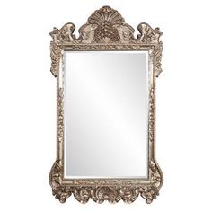 an ornate gold framed mirror on a white wall