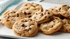 several chocolate chip cookies on a white plate