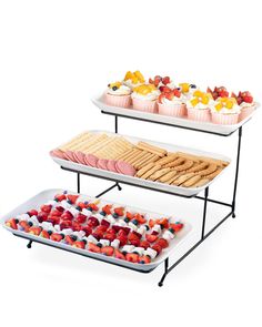 three tiered trays filled with different types of desserts and pastries on top of each other