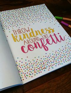 an open notebook with the words throw kindness around like confetti