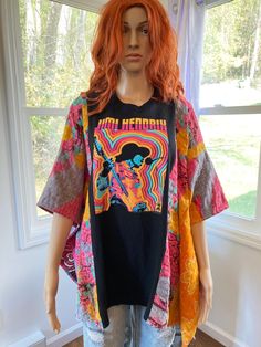 Jimi Hendrix psychedelic graphic t shirt upcycled into a beautiful loose fitting poncho top.  This top is one size fits all.  The poncho is constructed with cotton kantha fabric from recycled kantha blankets on the sides.  This fabric may contain patched areas and or flaws which is part of the character of kantha fabric.  The chest is 41.5 inches across, 83 inches around and it is 26.5 inches long.  The arm holes are 8.5 inches wide.  Machine wash cold gentle cycle tumble dry low. Multicolor Bohemian T-shirt For Beach, Multicolor Bohemian T-shirt For The Beach, Bohemian Multicolor T-shirt For Beach, Oversized Bohemian Cotton T-shirt, Bohemian Oversized Cotton T-shirt, Oversized Graphic Print Festival Tops, Oversized Graphic Print Tops For Festivals, Oversized Crew Neck Top For Festival, Multicolor Screen Print Tops For Festival