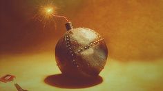 a silver ball with a sparkler on top of it