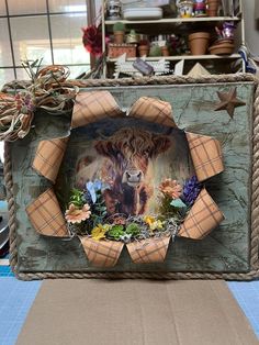 a cow is shown in the center of a photo frame with flowers and other items around it