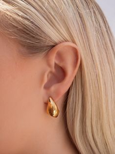 Earrings in Stainless Steel with Gold Plating Size: 21.6mm x 13mm Product code: WEAR_042 Designer's Notes Introducing our exquisite Drop Earrings, designed to add a touch of elegance and sophistication to any look. Perfect for both everyday wear and special occasions, their versatile style complements a wide range of outfits. Crafted with meticulous attention to detail, our Drop Earrings are the perfect accessory to elevate your ensemble with a touch of understated glamour. Please note that all our pieces are crafted by hand and one-of-a-kind, and may therefore vary slightly in size, shape, and color. 2.9.1.0 Luxury Pear-shaped Yellow Gold Earrings, Luxury Yellow Gold Pear-shaped Earrings, Formal Teardrop Huggie Earrings With Polished Finish, Sterling Silver Teardrop Huggie Earrings For Formal Occasions, Formal Teardrop Sterling Silver Huggie Earrings, Modern Pear-shaped Earrings For Anniversary, Teardrop Shaped Jewelry With Shiny Finish For Anniversary, Elegant Hallmarked Huggie Earrings For Formal Occasions, Tarnish Resistant Drop Huggie Earrings For Formal Occasions