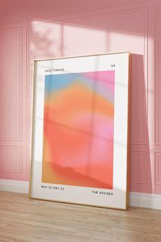 an abstract painting is displayed in front of a pink wall and wooden floor with light coming through the window