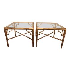 a pair of tables with glass top and bamboo frame, in the style of person