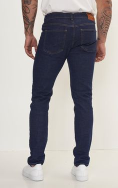 Fitted tapered jeans are a versatile and stylish choice for any wardrobe, offering a flattering silhouette and a modern look. These jeans are crafted from high-quality denim with a hint of stretch, ensuring both comfort and durability. The fitted style hugs the body in all the right places, accentuating curves while providing a sleek and streamlined appearance. The tapered leg adds a contemporary touch, narrowing towards the ankle for a flattering fit that pairs well with both sneakers and boots. Whether you're dressing for a casual day out or a night on the town, fitted tapered jeans can easily be dressed up or down. Pair them with a crisp button-down shirt and blazer for a polished look, or opt for a cozy sweater and sneakers for a more relaxed vibe. With their timeless appeal and versat Slim Fit Tapered Leg Jeans For Business Casual, Slim Fit Jeans With Tapered Leg For Business Casual, Blue Slim Fit Jeans For Business Casual, Modern Straight Fit Denim Jeans, Modern Straight Fit Dark Wash Jeans, Modern Dark Wash Straight Fit Jeans, Dark Wash Tapered Leg Jeans, Fitted Indigo Jeans With Tapered Leg, Dark Wash Tapered Mid-rise Jeans