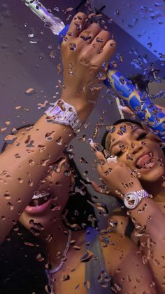 a woman holding an umbrella in front of her face while she is surrounded by raindrops