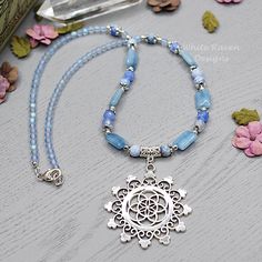 "A one of a kind, natural crystal witch aesthetic necklace featuring a beautiful flower of life, mandala pendant. This Blue Agate crystal beaded necklace was created with  blue agate, denim quartz and Vintage Czech glass beads with lead and nickel free silver accents. This boho necklace is finished with a silver plated lobster clasp and I can add an extender chain if you wish (just comment in the note to seller at checkout) At \"matinee length\" this flower of life necklace is designed to sit ju Crystal Witch Aesthetic, Blue Agate Crystal, Flower Of Life Mandala, Mandala Pendant, Crystal Witch, Aesthetic Necklace, Gemstone Beads Jewelry, Crystal Bead Necklace, Witchy Jewelry