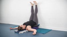 a woman is laying on her stomach while doing an exercise