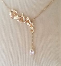 Beautiful necklace features gold plated over brass orchid flowers with a teardrop Cubic Zirconia crystal dangling below . Pendant connected to a dainty gold plated over brass chain. Great accessory for yourself or give as gift to special one!! Please convo me if your desire necklace length is not on the listing. Length of orchid flowers: 2.25 inches; Length of dangling chain + CZ crystal: 1.5 inches For matching earrings: https://www.etsy.com/hk-en/listing/660766094/ Purchase over $40 enjoys fre Delicate Gold Drop Necklace For Anniversary, Gold Dangle Drop Necklace For Wedding, Gold Pendant Lariat Necklace For Wedding, Gold Lariat Pendant Necklace For Wedding, Delicate Gold Drop Backdrop Necklace, Gold Flower Necklace With Delicate Chain For Wedding, Delicate Gold Drop Necklace For Wedding, Gold Necklace With Flower Charm For Wedding, Gold Necklaces With Flower Charm For Wedding