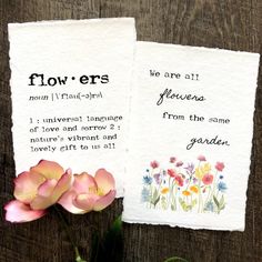 two flowers sitting next to each other on top of a piece of paper that says flower ers